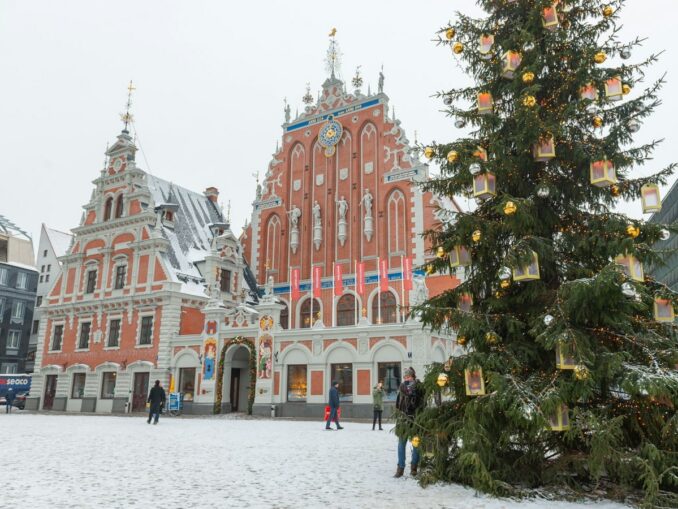 New Year's Riga often sees snow, photo unsplash.com/@Mony Misheal House of the Blackheads and New Year's tree in Riga in January