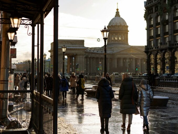View of the Kazan Cathedral - people wear winter clothes to St. Petersburg in March