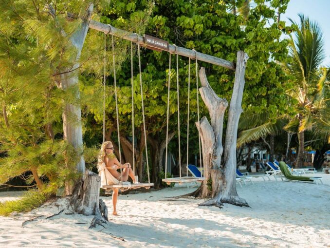 Girl on the beach - it’s worth going to Zanzibar in August for a seaside holiday! 